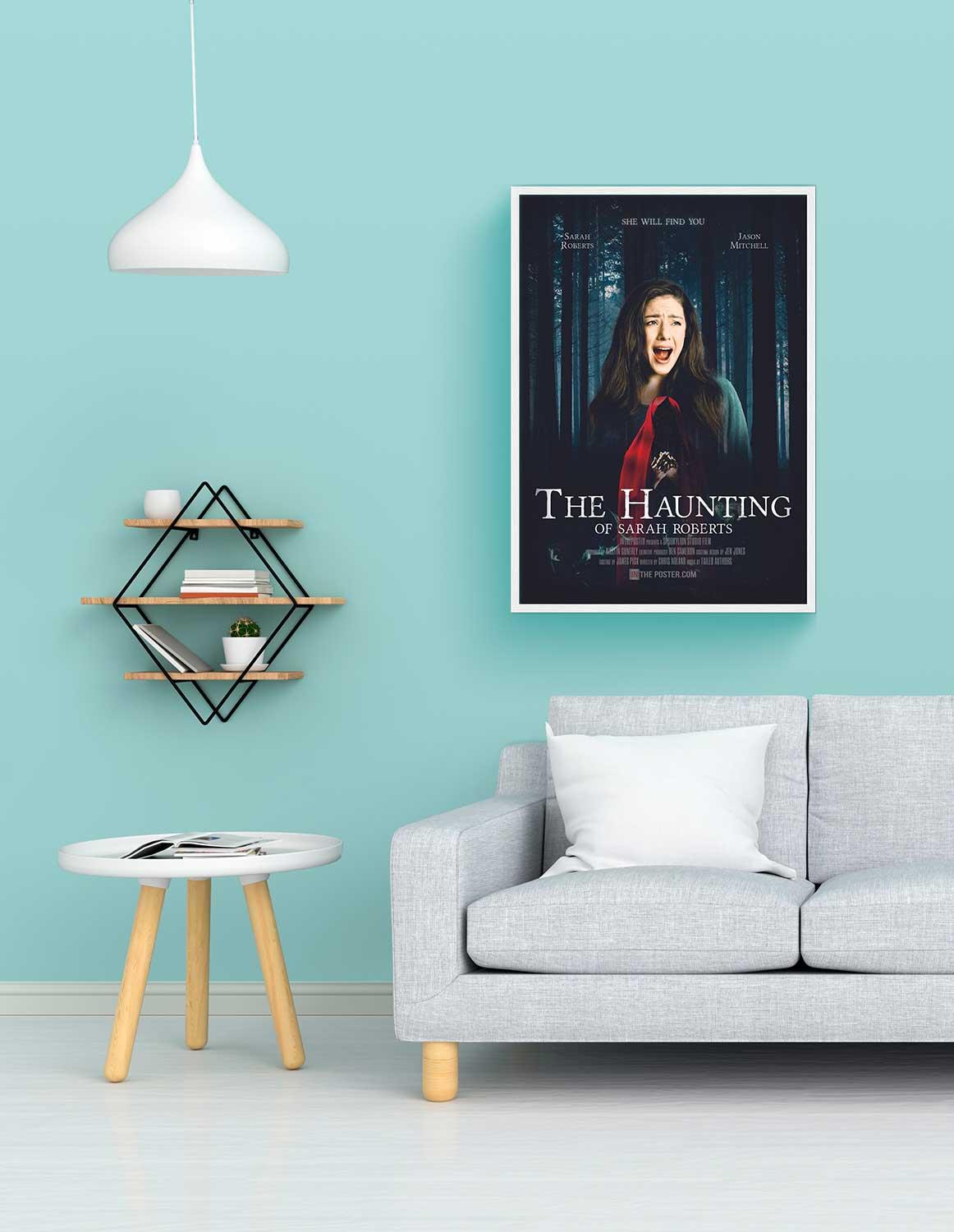 The Haunting Personalised film poster, regular size in a white frame above a sofa with a blue wall.