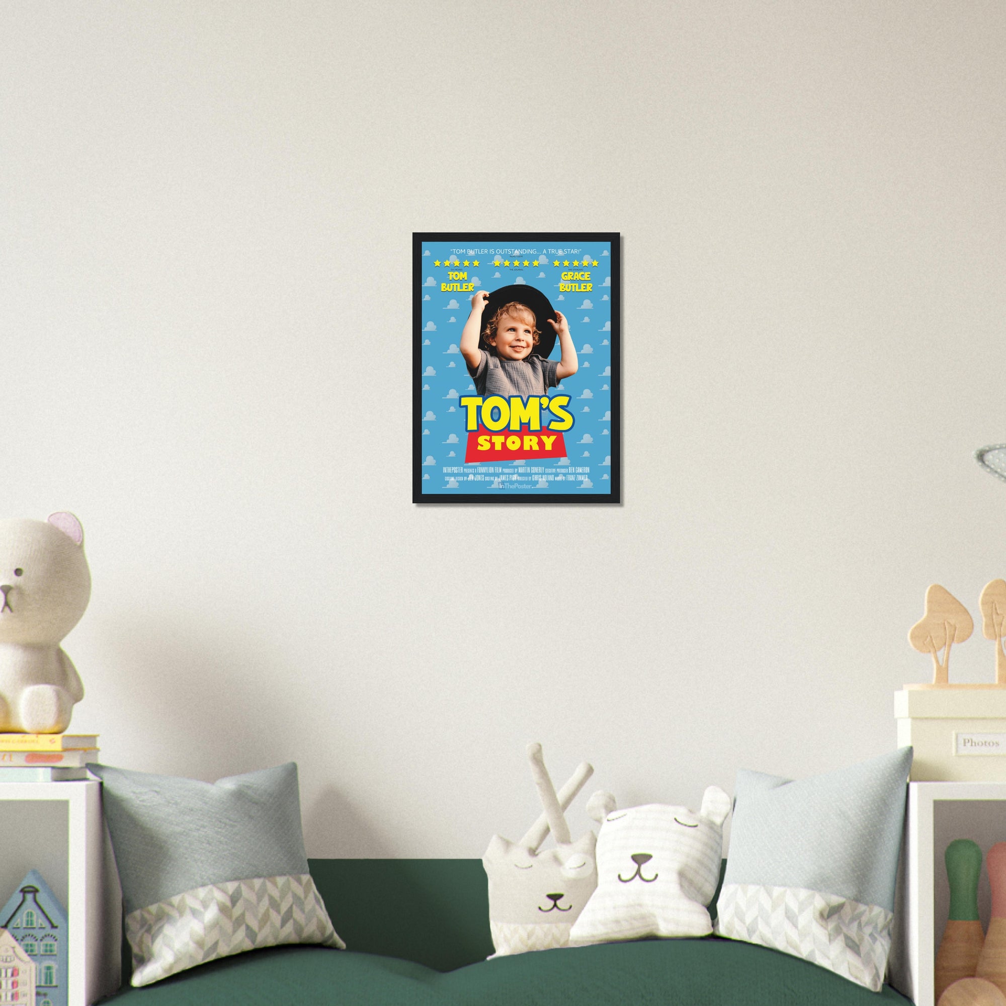 A Toy Story inspired movie poster design in a small black frame, on a grey wall in a kids bedroom