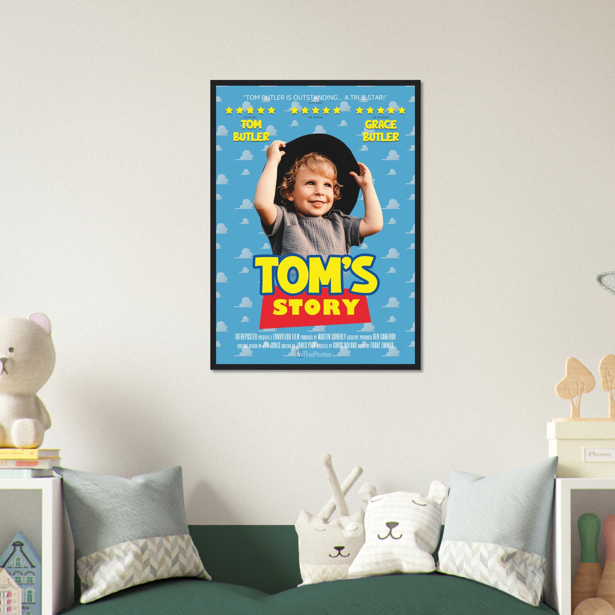 A Toy Story inspired movie poster design in a regular black frame, on a grey wall in a kids bedroom