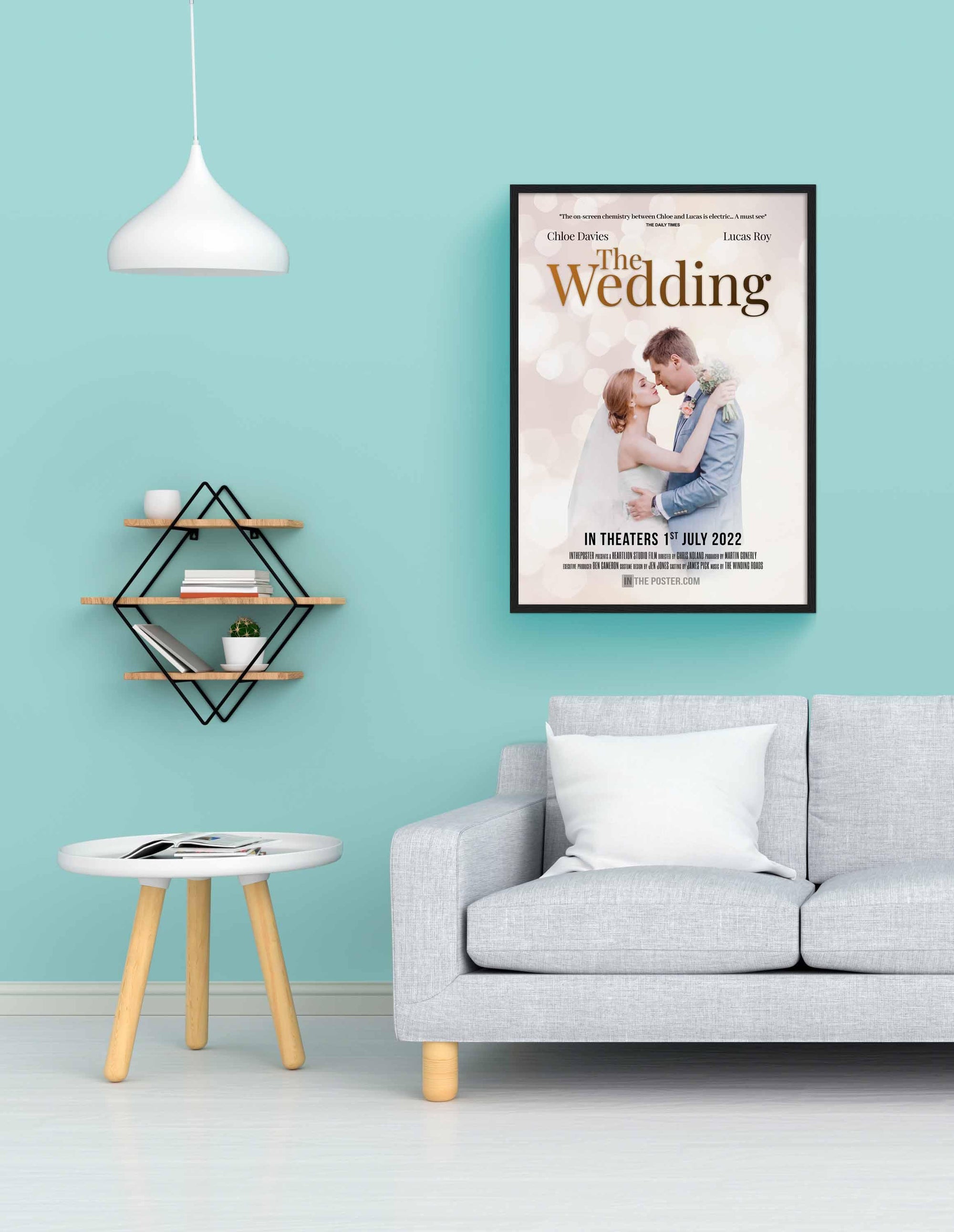 The Wedding - Movie Poster in Regular Black Frame on a blue wall above a grey sofa