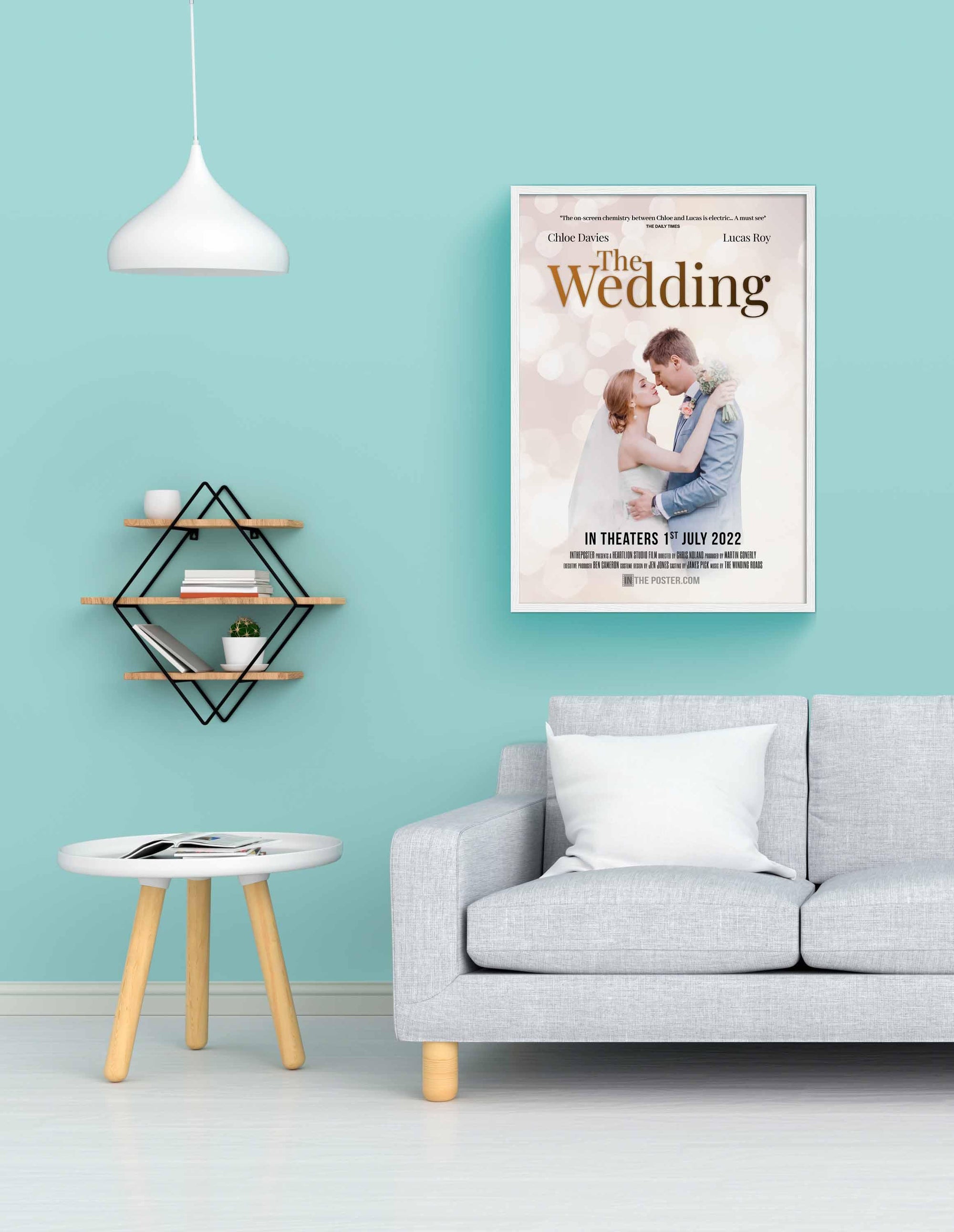 The Wedding - Movie Poster in Regular White Frame on a blue wall above a grey sofa