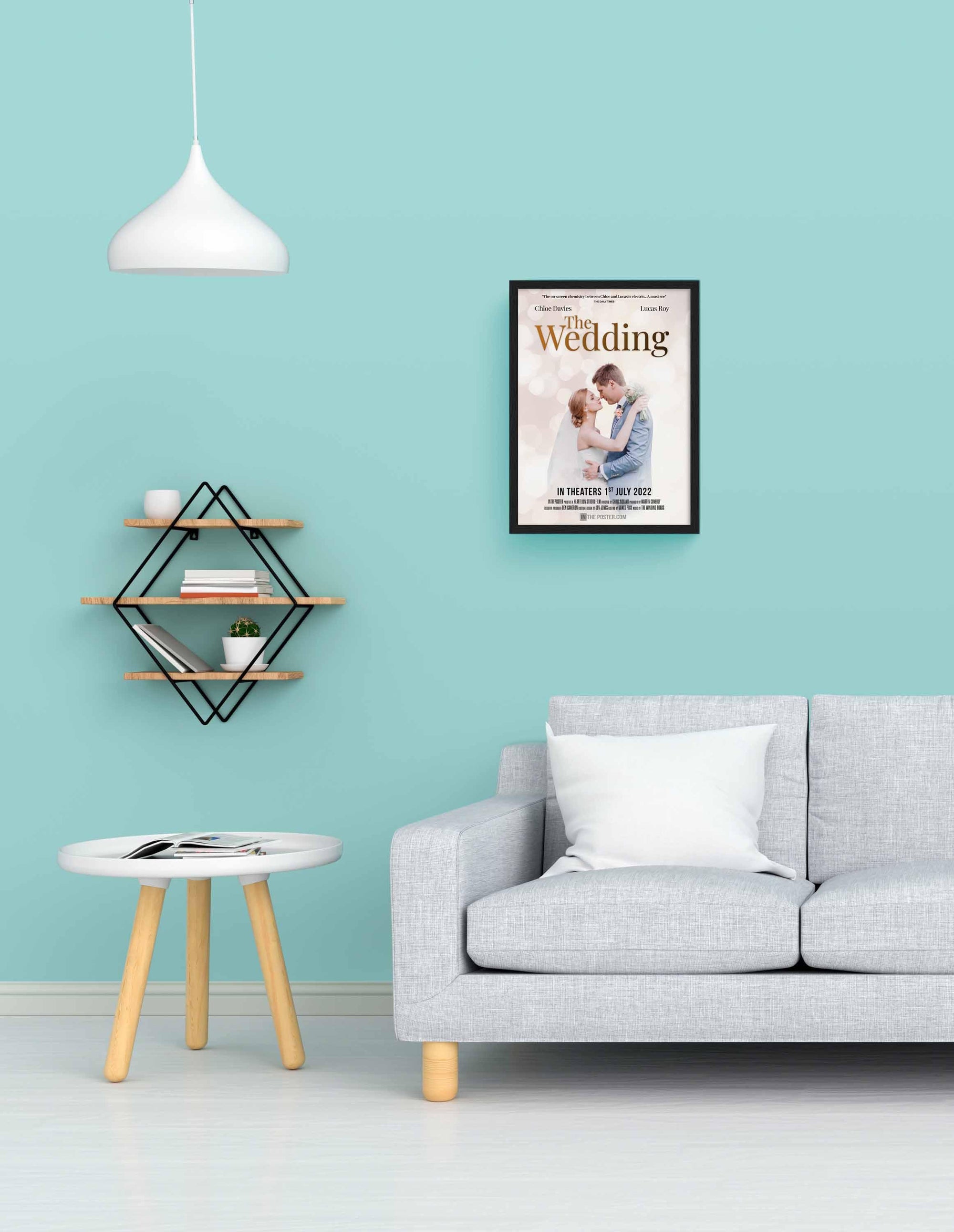 The Wedding - Movie Poster in Small Black Frame on a blue wall above a grey sofa