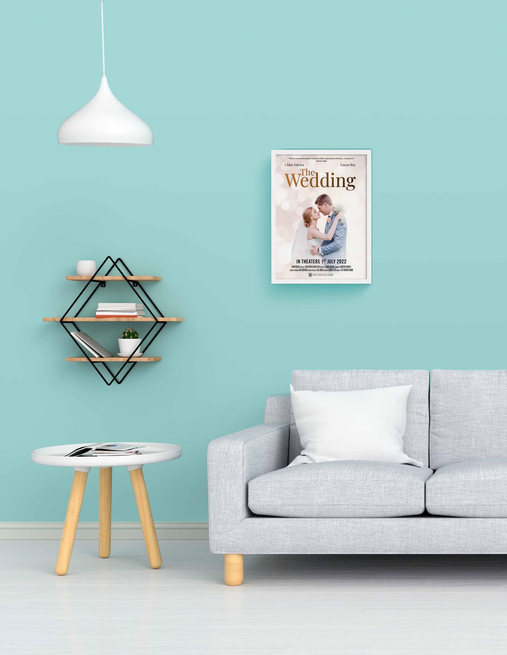 The Wedding - Movie Poster in Small White Frame on a blue wall above a grey sofa