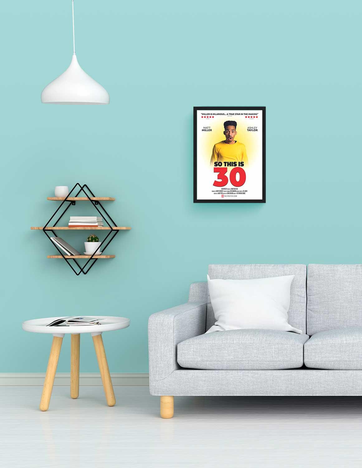 So This is 30 - personalized comedy movie poster, small size, with a black frame on a wall above a sofa