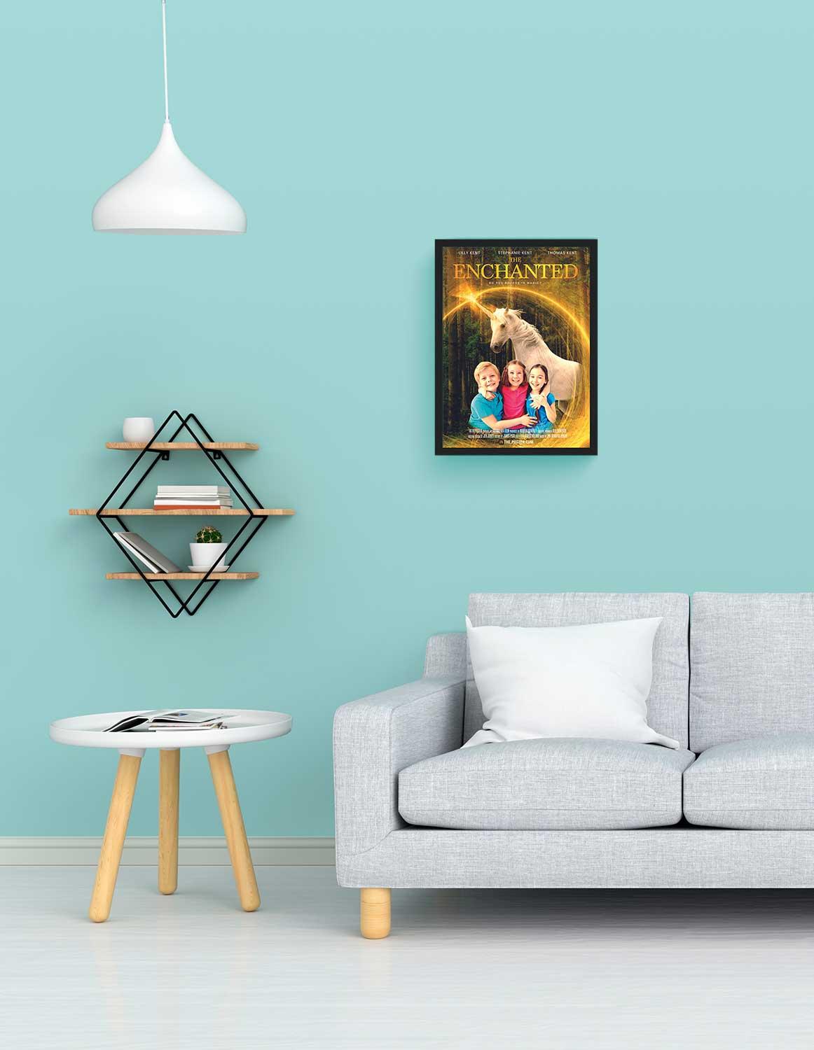 A unicorn movie poster in a small black frame above a grey sofa