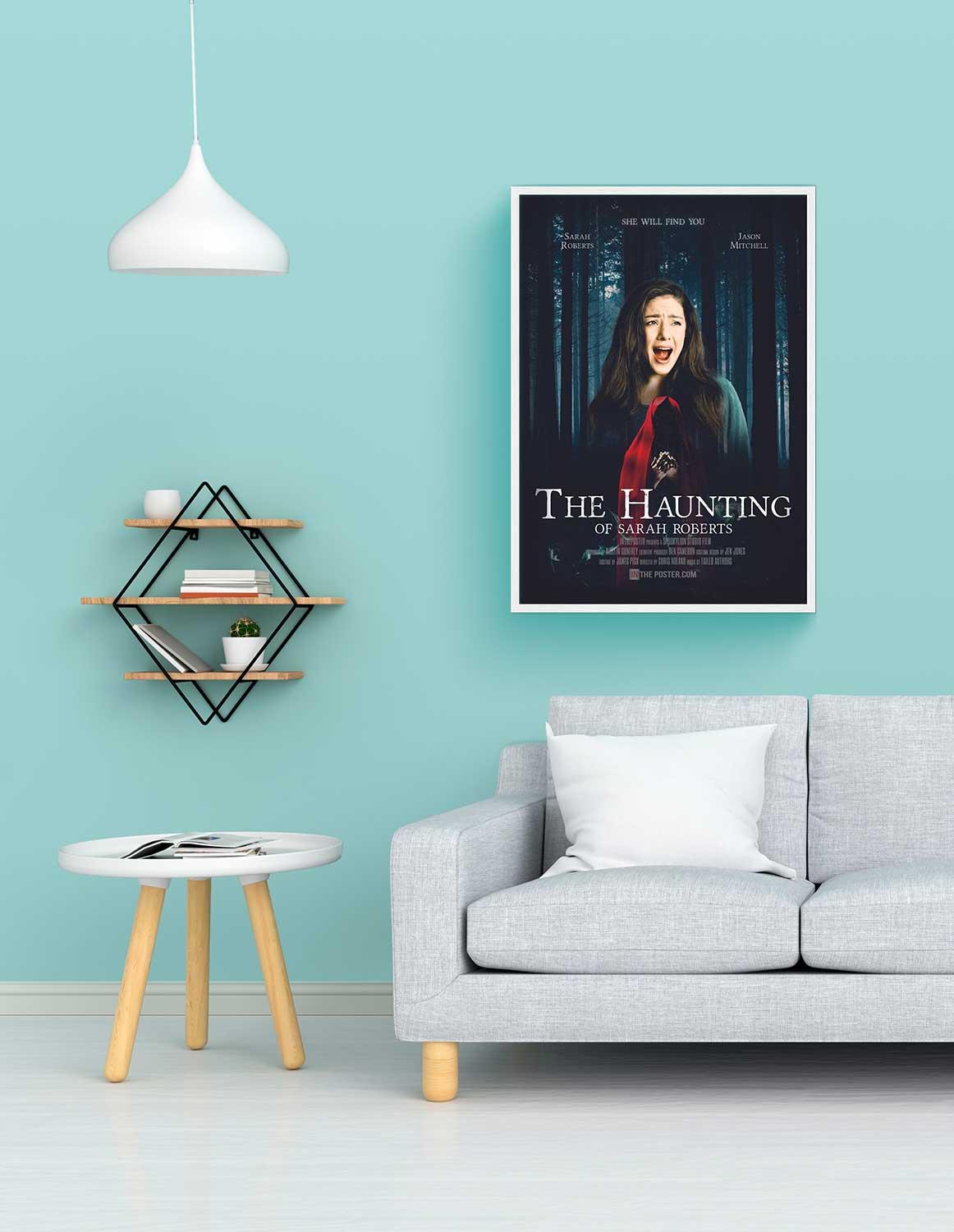 The Haunting Personalised film poster, regular size in a white frame above a sofa with a blue wall.