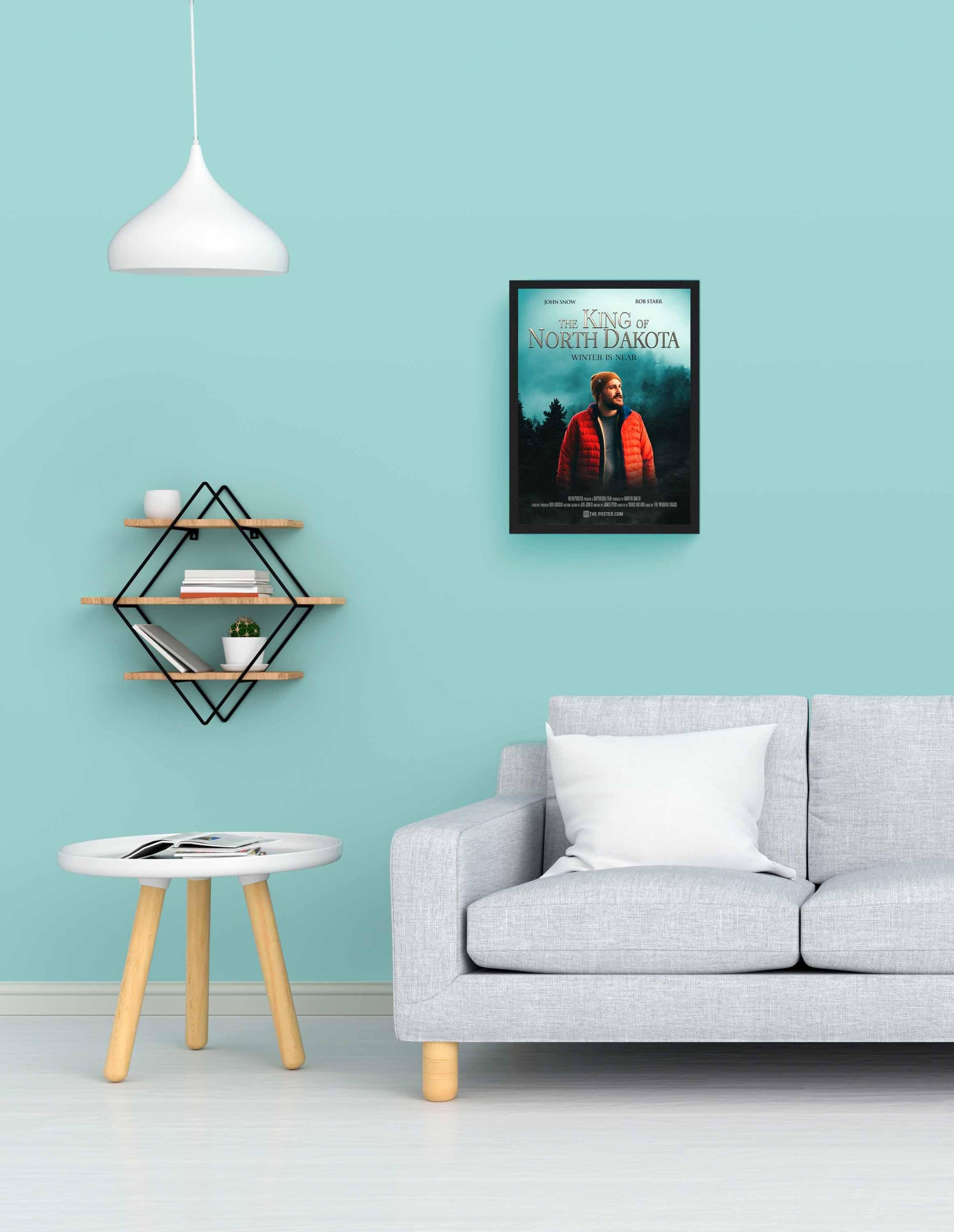 Fantasy custom movie poster in a black small frame on a blue wall above a grey sofa