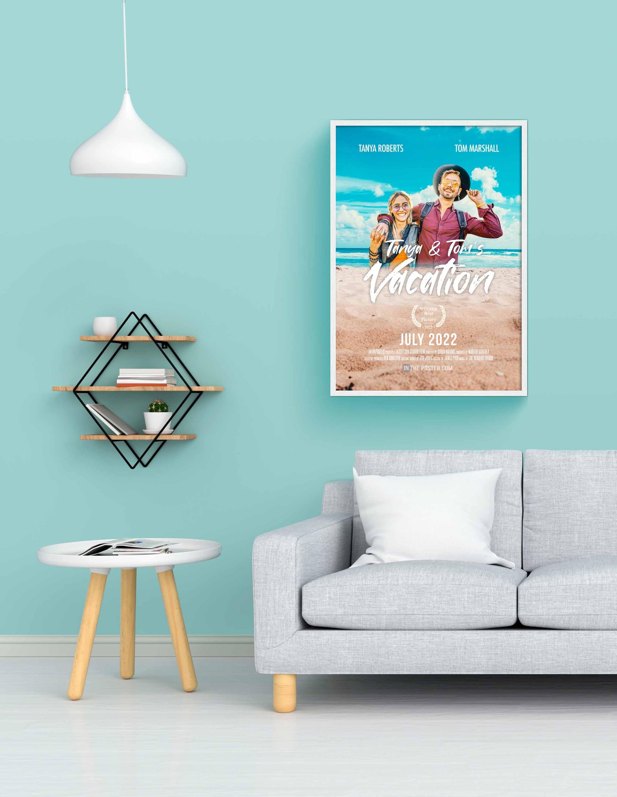 The Vacation Custom Movie Poster with travel buddies in a white picture frame on a blue wall above a grey sofa