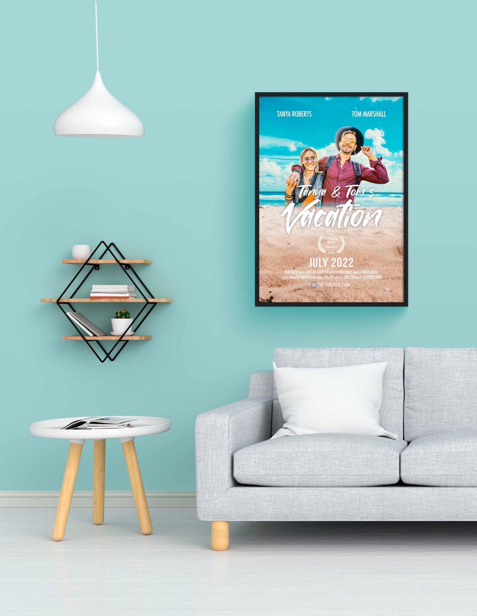 The Vacation Custom Movie Poster with travel buddies in a black picture frame on a blue wall above a grey sofa